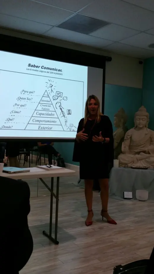 A speaker presenting a slide