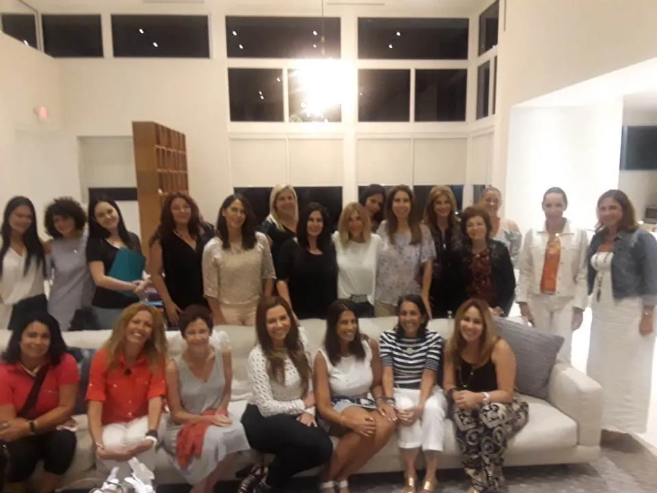 A large group of participants seated on sofas