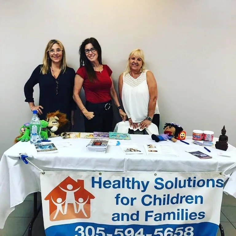 Three team members at the Healthy Solutions information table