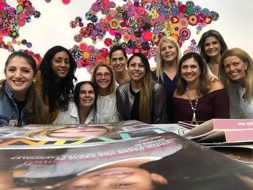 A group of participants in front of a colorful wall