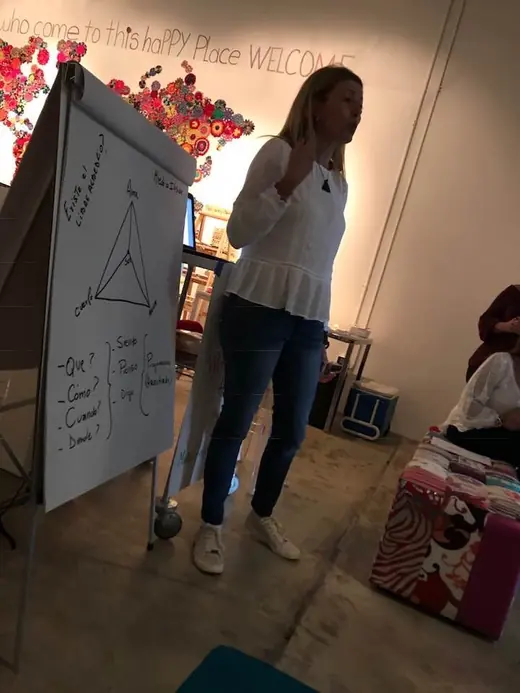 A facilitator presenting next to a flip chart