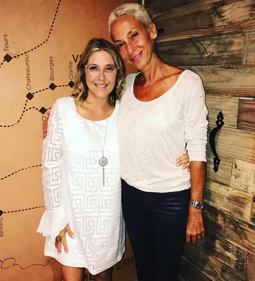 Two women smiling at a gathering
