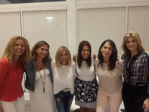 A group of seven women smiling